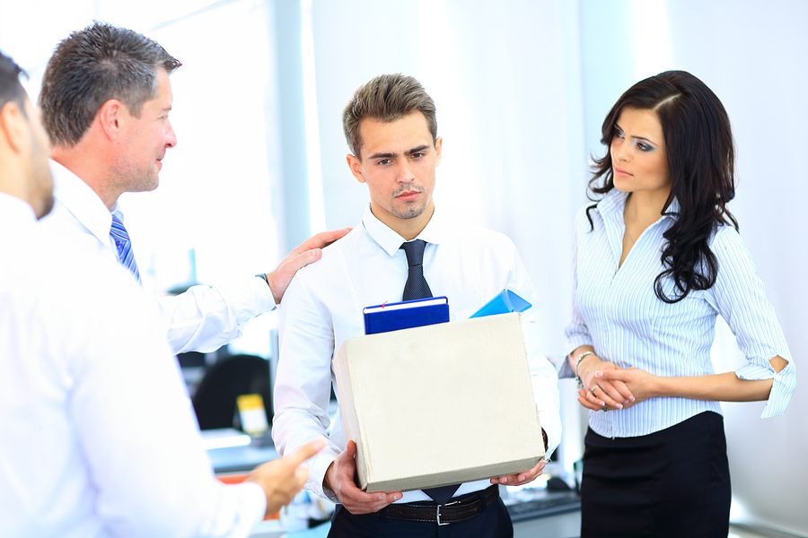 dismissed businessman carrying box